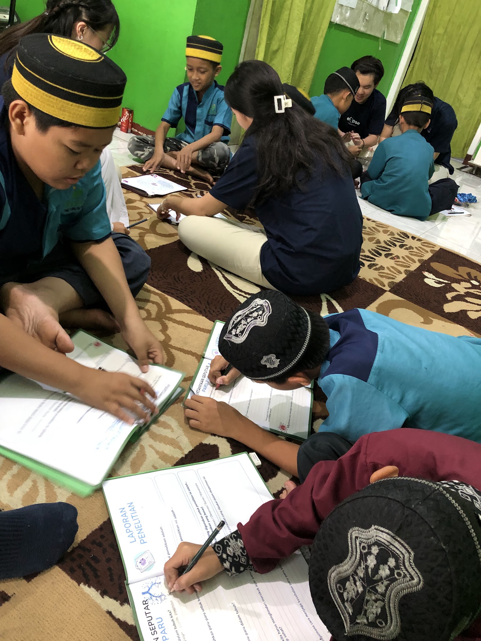 Volunteers supporting a group using illustrated workbooks
