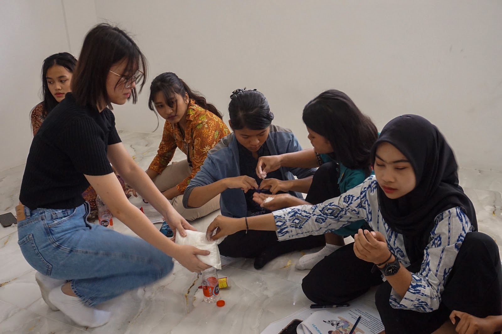 Volunteers and learners sitting together for a community activity