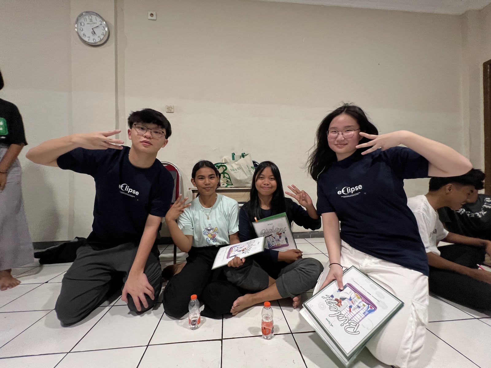 Volunteers and learners gathered with activity books