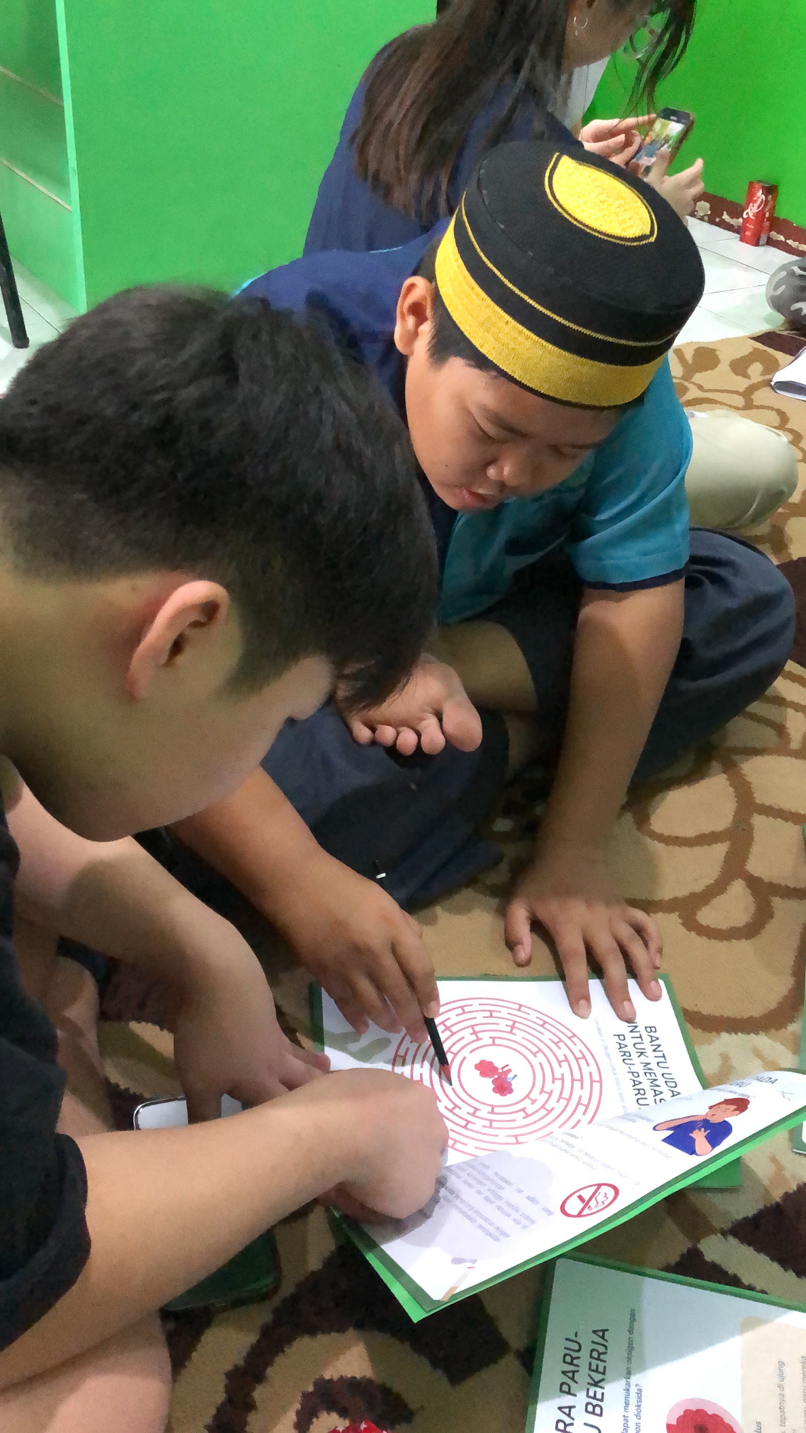 A volunteer and learners exploring an illustrated workbook