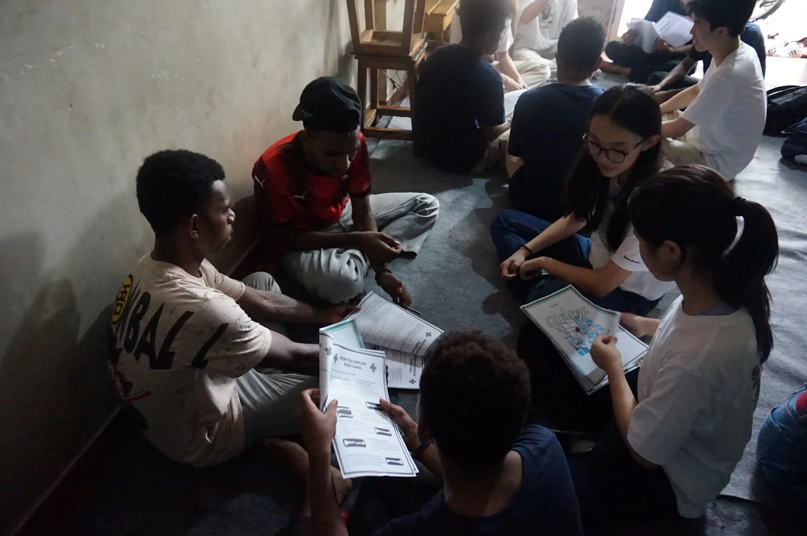 Learners and volunteers exploring activity sheets in a small group
